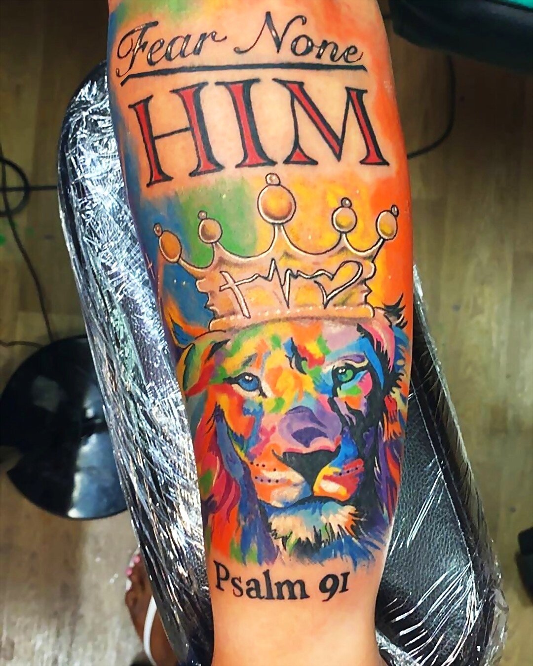 Watercolor lion tattoo with the words Fear None But Him, Psalm 91